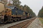 CSX 5465 and 117 wait for green with a line of covered hoppers at the N.E. Aberdeen signals
